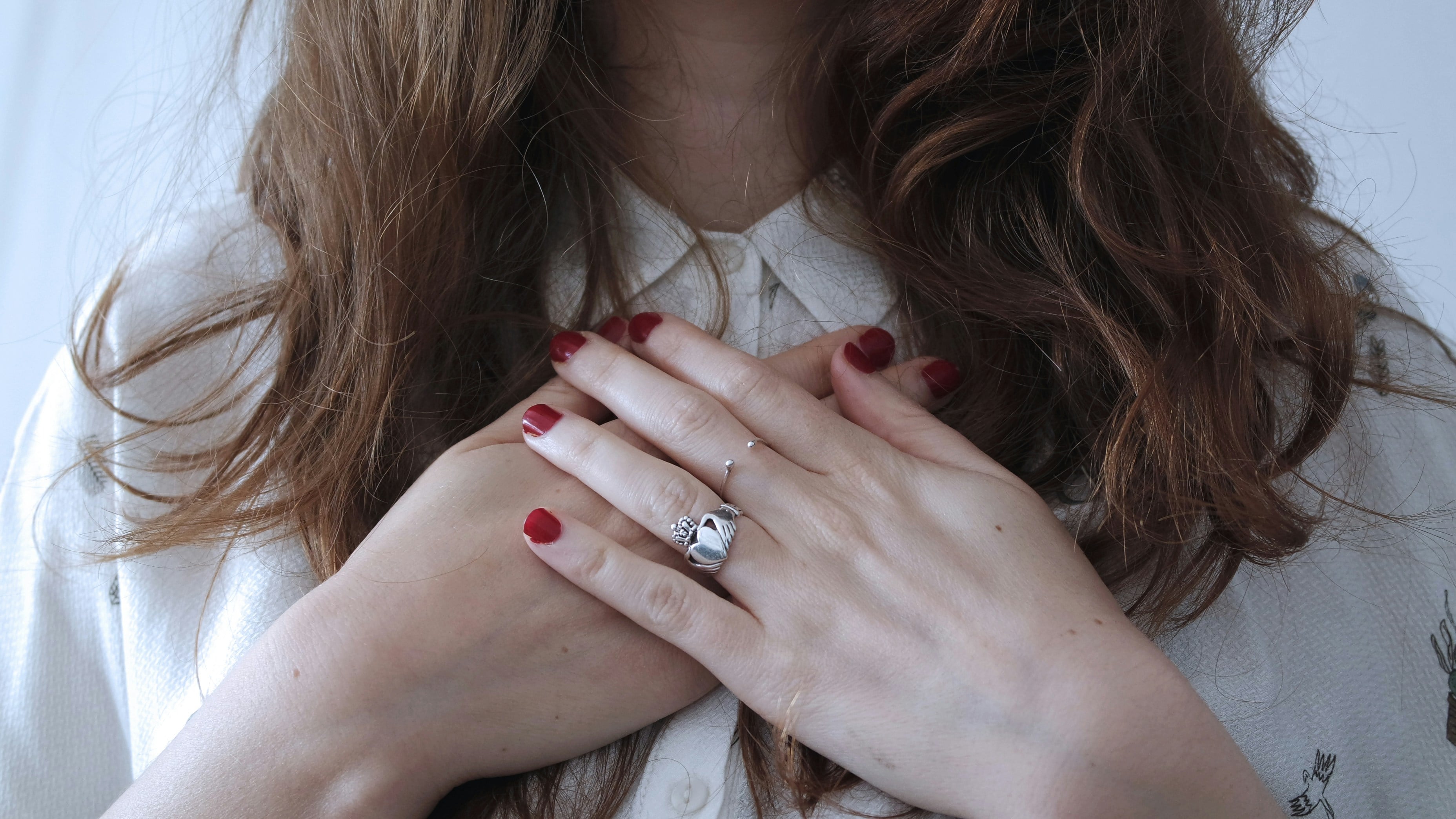 Woman with hands on her chest